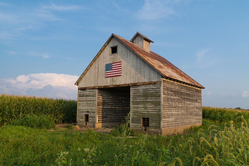 Old rustic barn in the Midwest with painted American flag