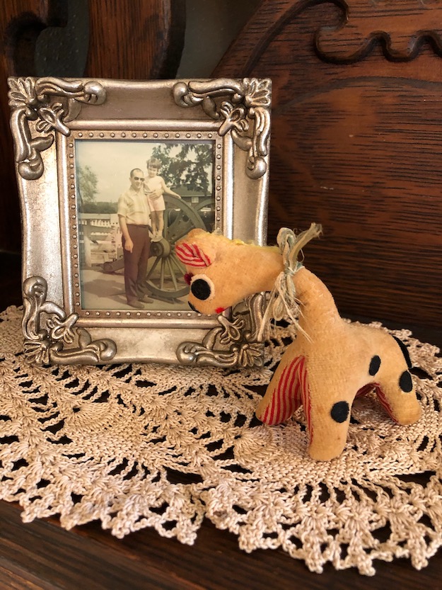 toy giraffe and small framed photo of father and young daughter