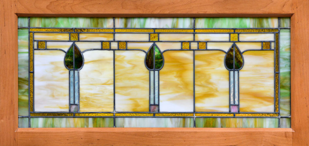 stained glass window with 3 candles