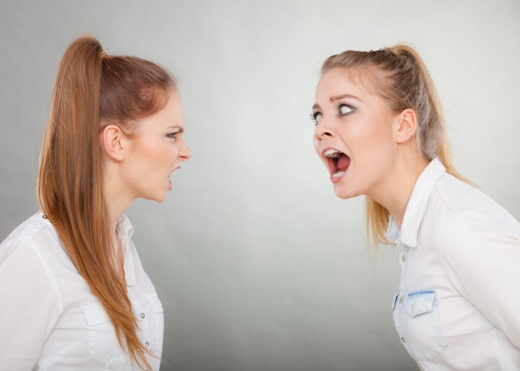 photo of two young nurses arguing